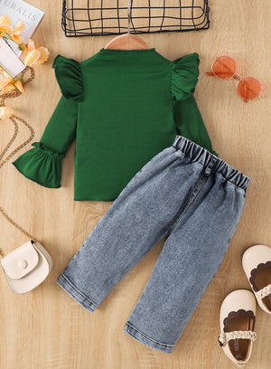 Green ribbed top with ruffle sleeves and light wash jeans with elastic waistband.