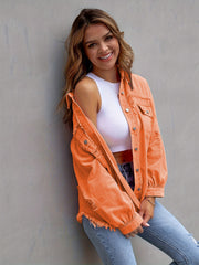 Tangerine distressed denim shacket with frayed hem and cuffs.