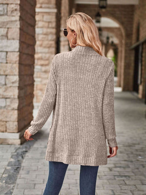 Tan ribbed open-front cardigan with long sleeves and pockets.