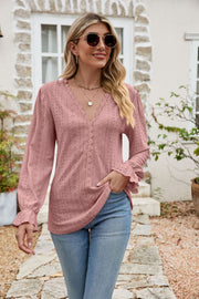 Blush pink eyelet lace blouse with ruffle sleeves and V-neckline.