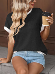 Black textured knit short-sleeve t-shirt with white trim, worn by a woman holding a coffee cup.