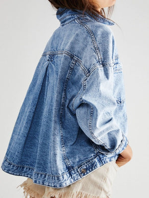 Oversized light blue denim trucker jacket with button details and a relaxed fit.