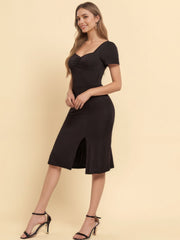 Black ruched sweetheart neck midi dress with short sleeves and a side slit.