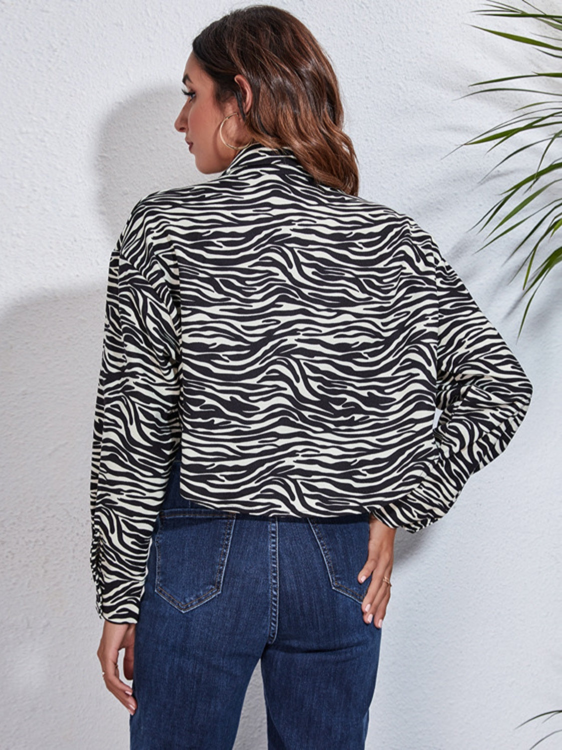 Checkerboard cropped shirt jacket in zebra print with button details.