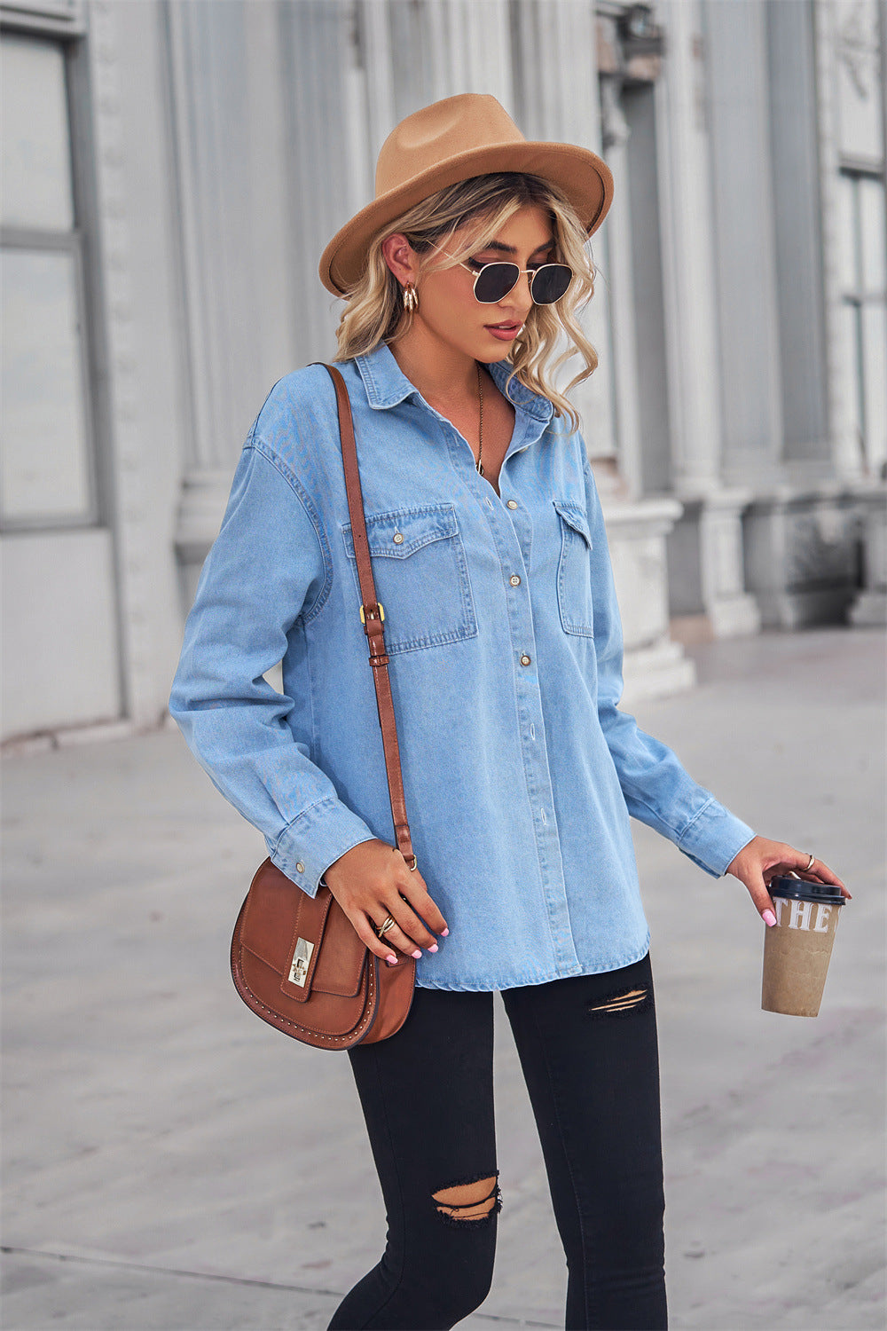 Light wash oversized denim shirt with patch pockets, collared neck, and buttoned front.
