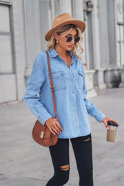 Light wash oversized denim shirt with patch pockets, collared neck, and buttoned front.