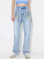 Light wash denim jeans with embroidered floral pocket details and "No Bad Days!" text.