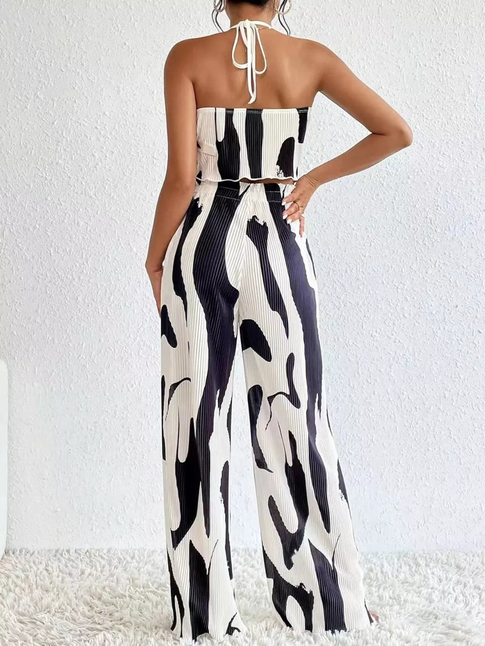 Black and white abstract print halter crop top and wide leg pants set, polyester.