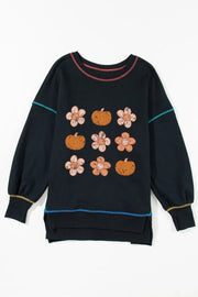 Black sweatshirt with floral and pumpkin embroidery and contrast stitching.