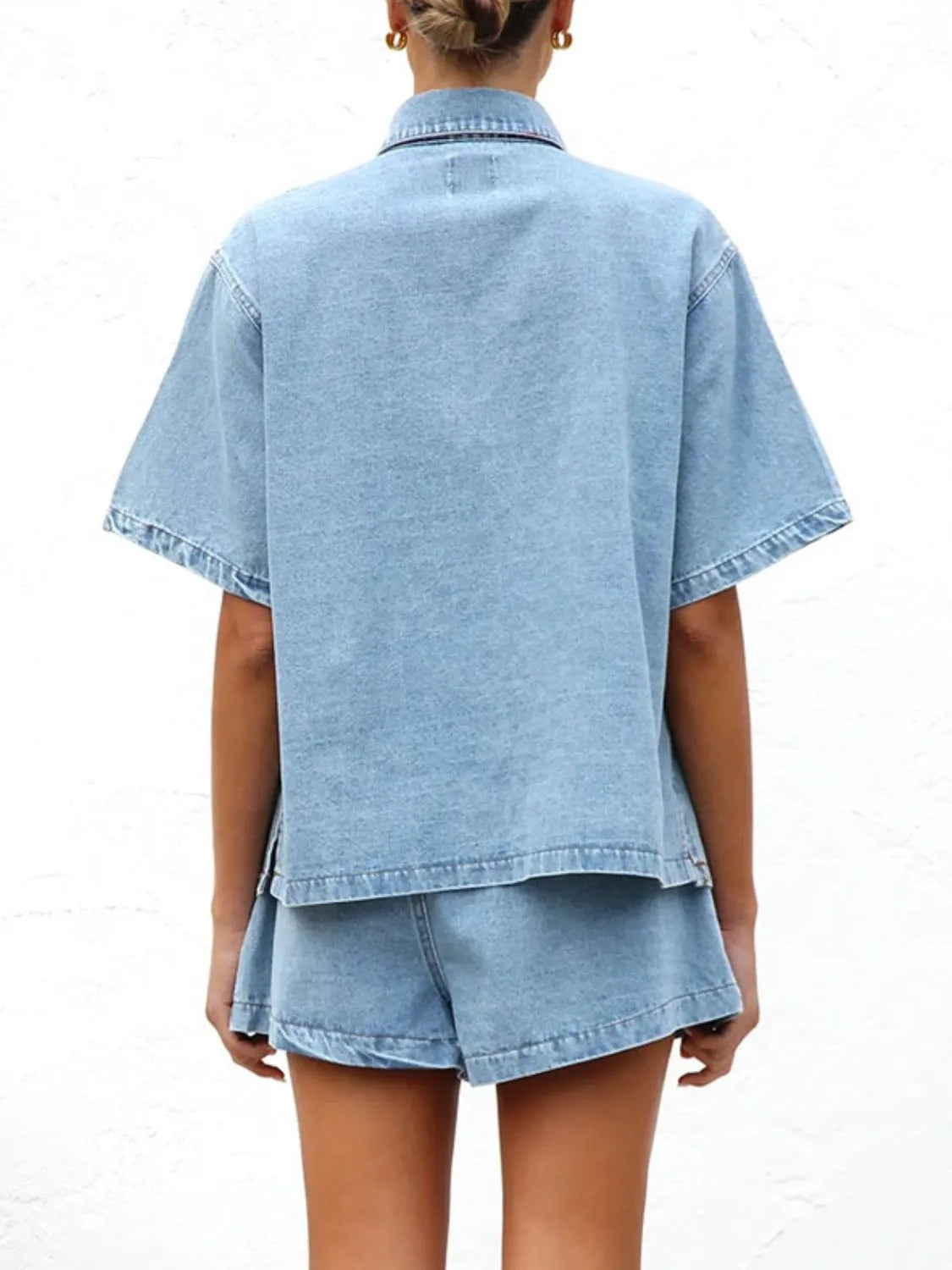 Light wash denim co-ord set with short sleeve button-up shirt and shorts.