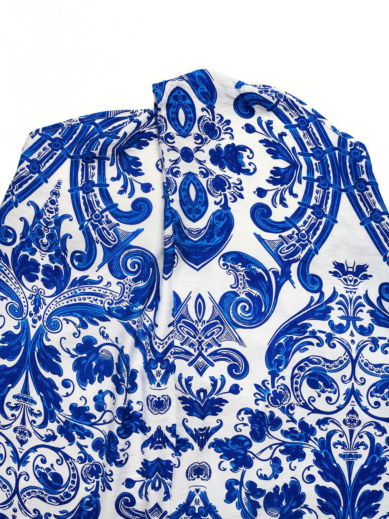 Blue and white patterned maxi dress with crisscross halter neckline detail