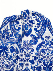 Blue and white patterned maxi dress with crisscross halter neckline detail