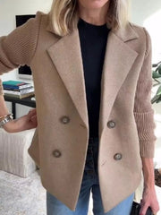 Tan double-breasted trench coat with knit sleeves and button closure.