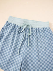 Light blue checkerboard shorts with a light blue drawstring waist and elastic band.