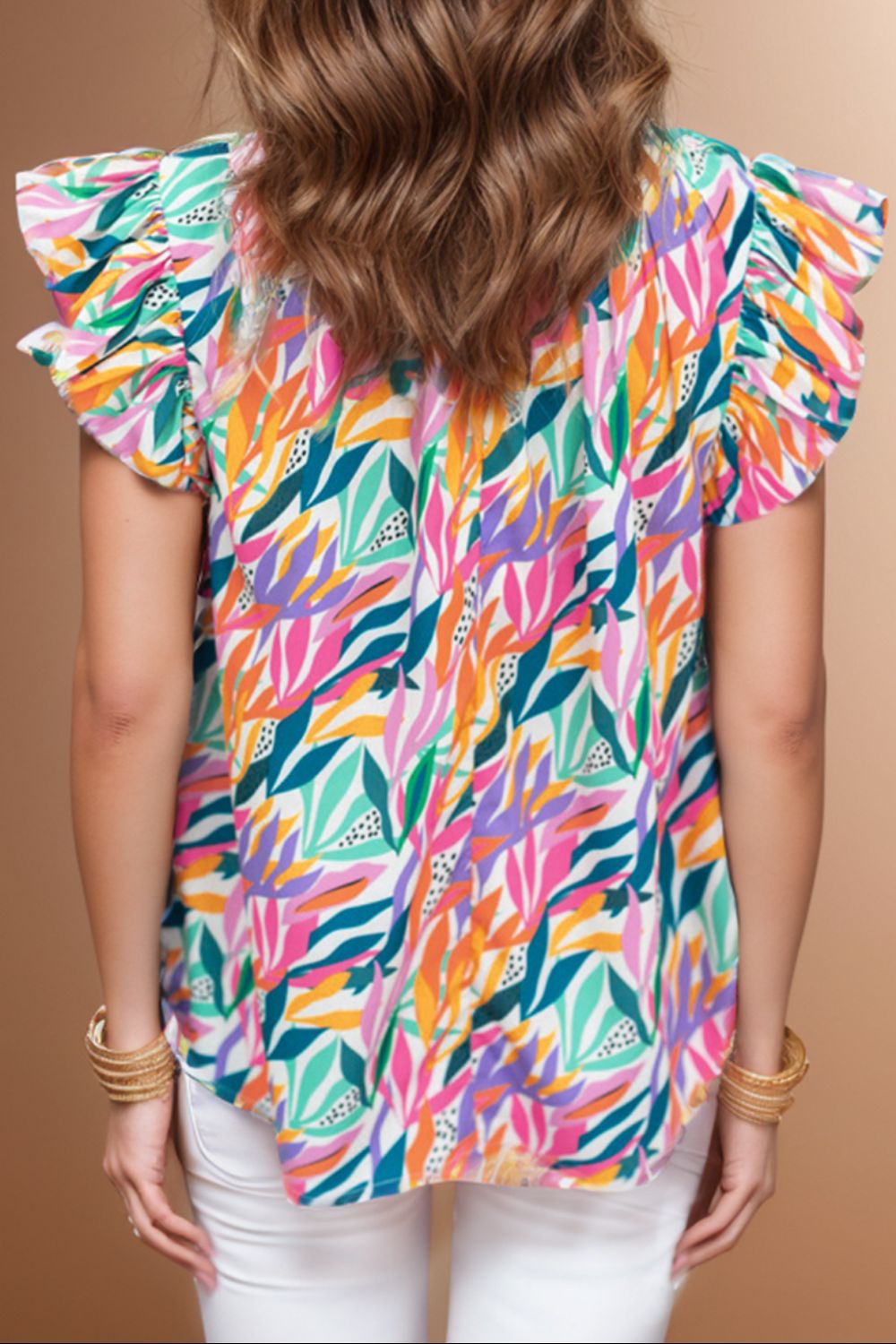 Multicolor leaf print blouse with ruffled short sleeves and a ruffled collar.