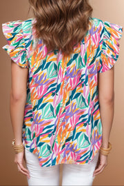 Multicolor leaf print blouse with ruffled short sleeves and a ruffled collar.