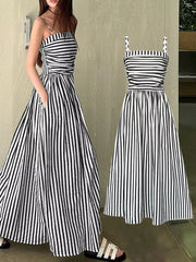 Black and white striped maxi dress with spaghetti straps, smocked bodice, and side slit.