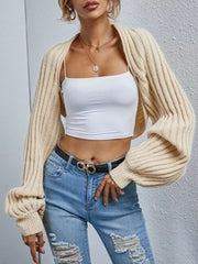 Beige knit cropped cardigan with balloon sleeves and ribbed detail.