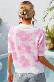 Pink floral knit polo with contrast collar and short sleeves.