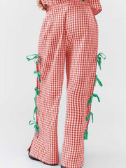 Gingham wide-leg trousers in Scarlet with green bow details on the side seams.