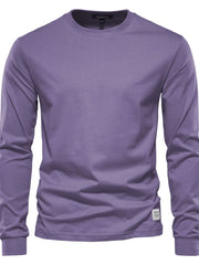 Essential crewneck long sleeve t-shirt in mauve with a small white tag detail on the hem.