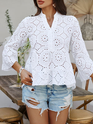 White eyelet embroidered peplum blouse with ruffles and bell sleeves.