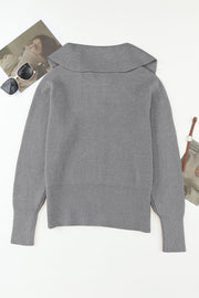 Gray ribbed knit cardigan with a shawl collar and cuffed sleeves.