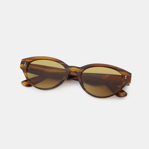 Tortoiseshell oval acetate sunglasses with brown lenses and gold accents.
