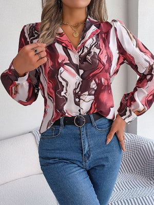 Women's abstract swirl print silk blouse with button front and collared neckline.