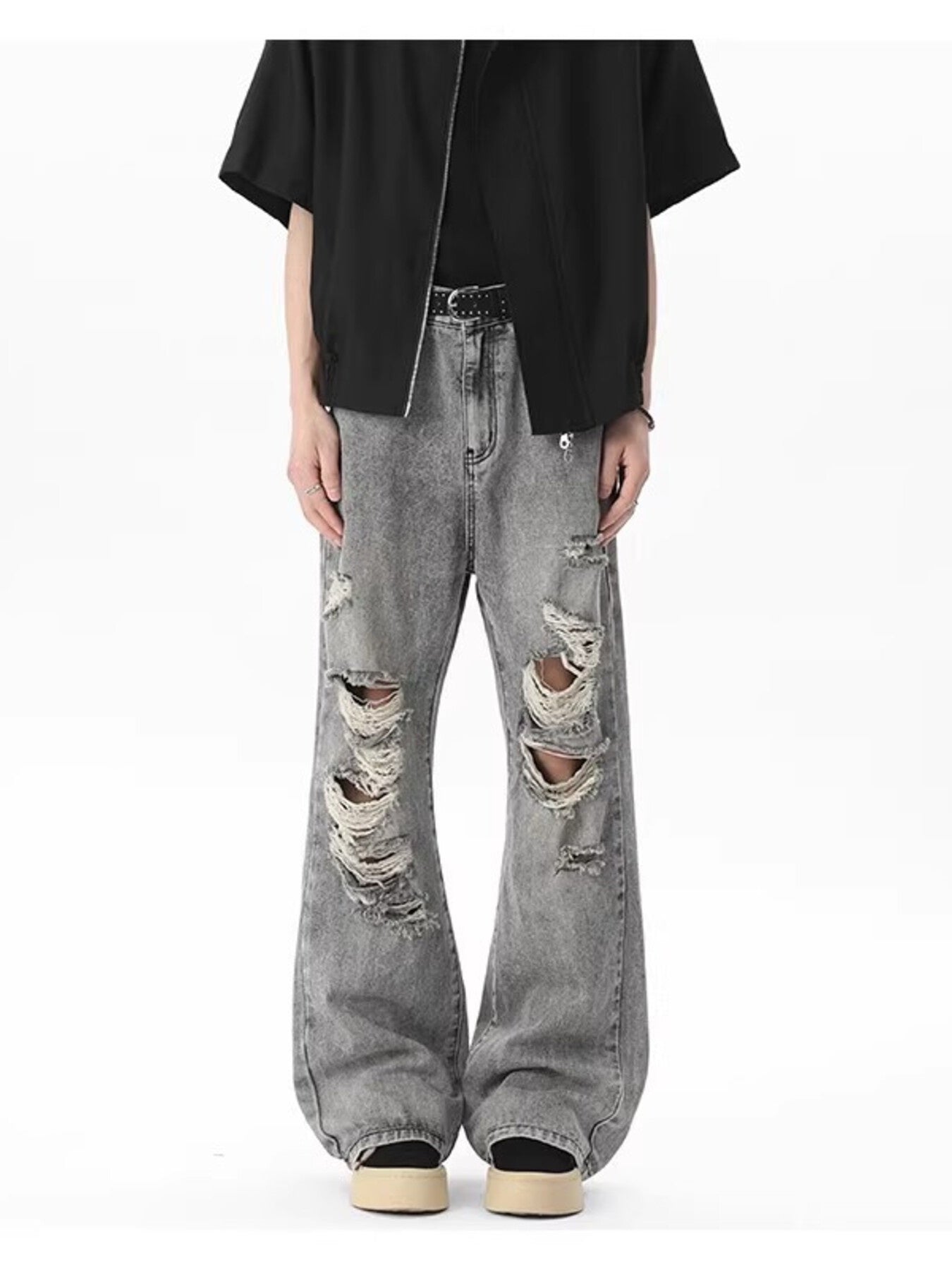 Men's light gray distressed wide-leg jeans with frayed details.