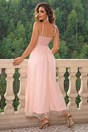 Blush pink sequin bodice maxi dress with spaghetti straps and tulle skirt.