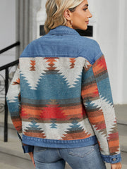 Southwestern denim trucker jacket in dusty blue with a geometric pattern and button closure.