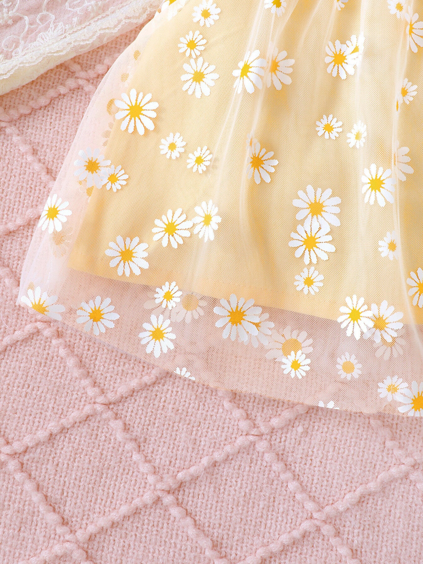 Yellow baby set with daisy print and sheer overlay.