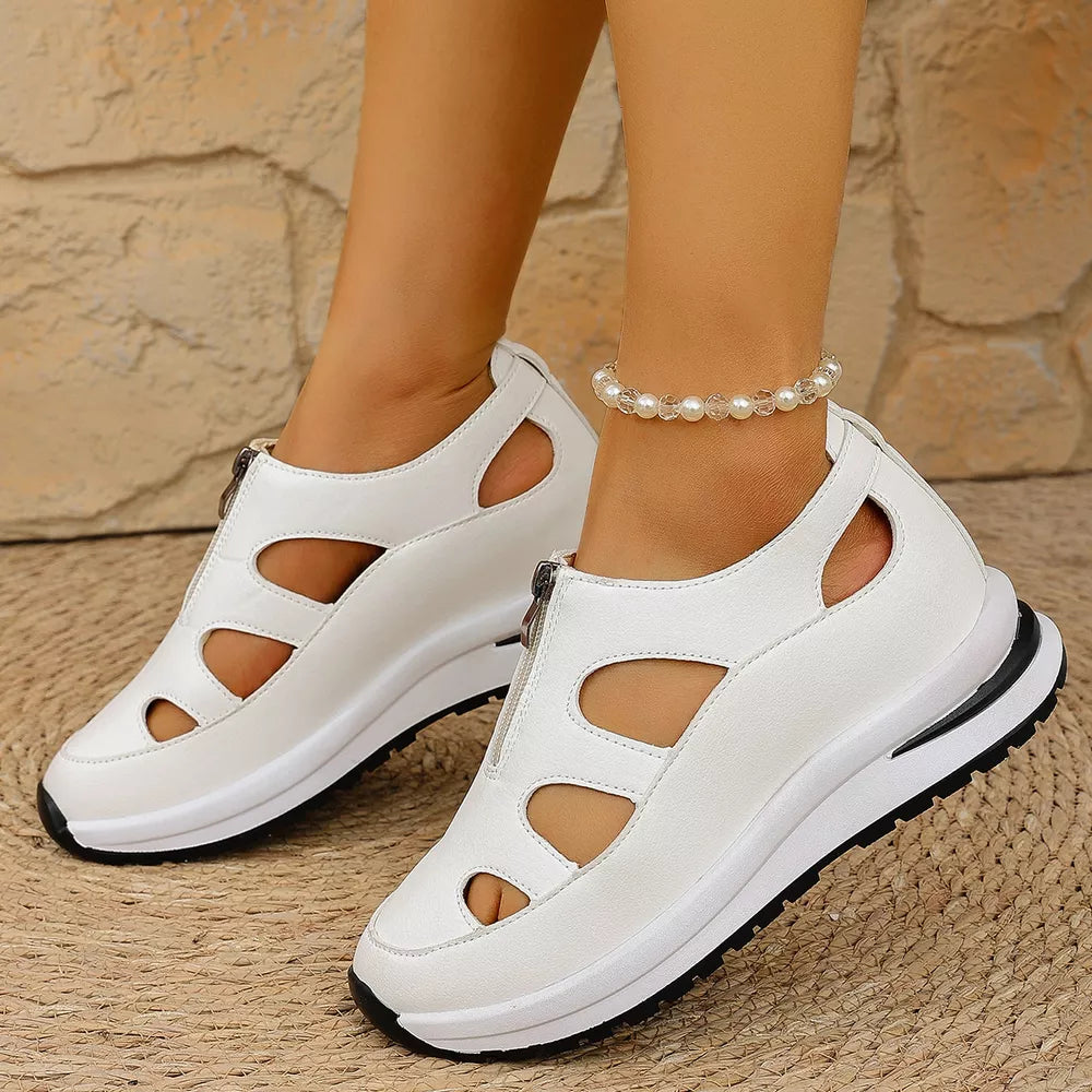 White cutout wedge sneakers with zipper detail and chunky sole