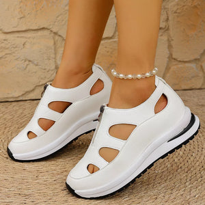 White cutout wedge sneakers with zipper detail and chunky sole