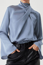 Dusty blue satin blouse with draped neckline and bell sleeves.