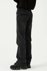 Black denim straight leg jeans with panel seams and a relaxed fit.