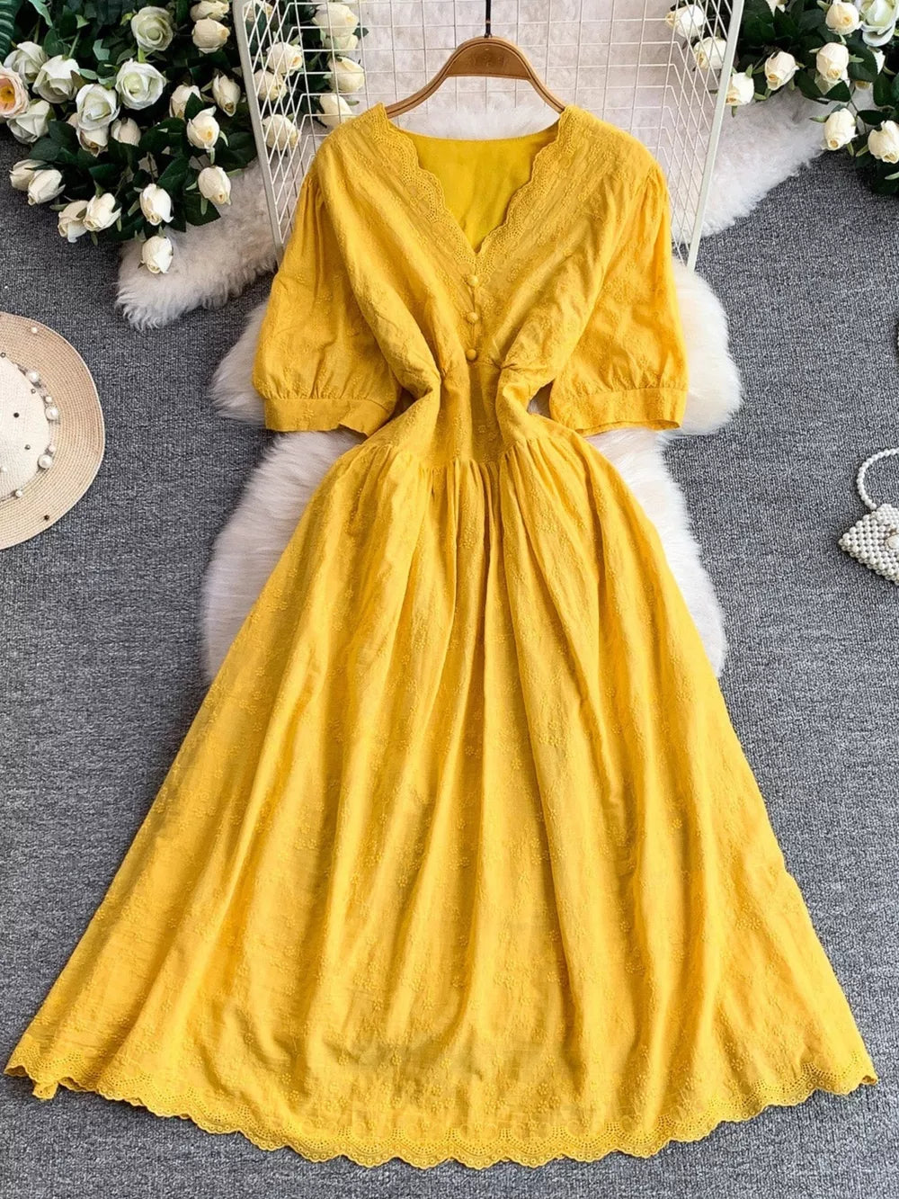 Yellow lace-embellished A-line midi dress with V-neck and button detail