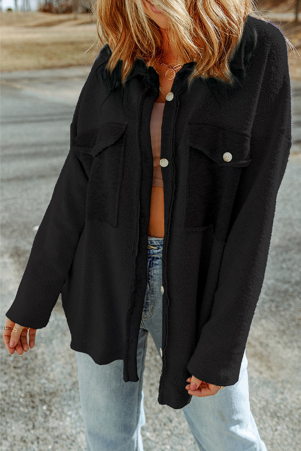 Black button-up shacket with chest pockets and textured fabric.