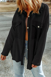 Black button-up shacket with chest pockets and textured fabric.