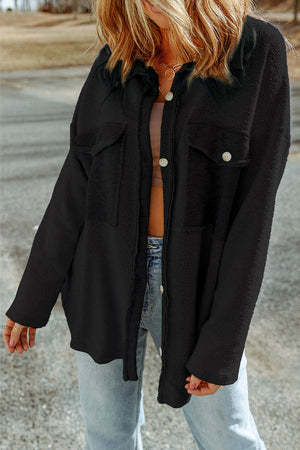 Black button-up shacket with chest pockets and textured fabric.
