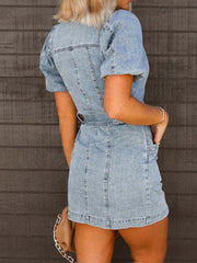 Belted denim mini dress in medium wash with puff sleeves and a cinched waist.