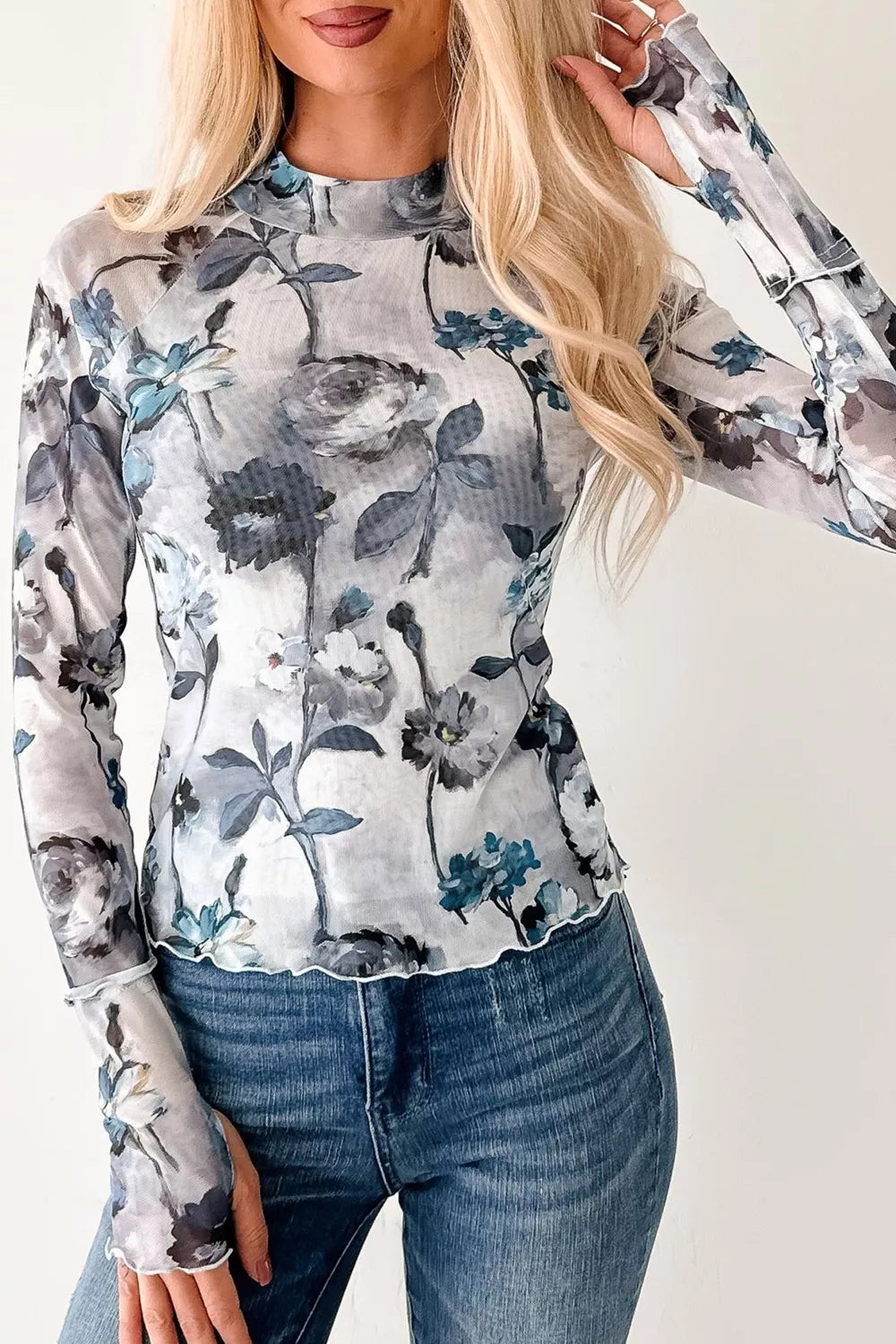 Sheer floral high neck long sleeve shirt with lettuce hem detail.