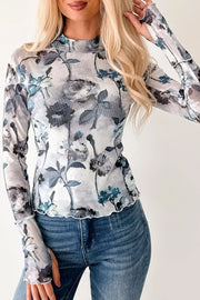 Sheer floral high neck long sleeve shirt with lettuce hem detail.