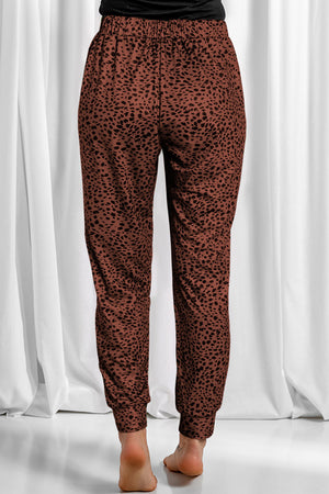 Brown leopard print jogger trousers with elastic waistband and cuffed ankles.