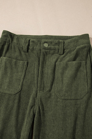 Moss corduroy flared leg trousers with front patch pockets and button closure.