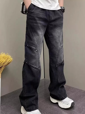 Distressed black wide-leg jeans with panel detailing and a vintage wash.