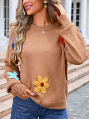 Camel knit sweater with embroidered flower appliqués and ribbed cuffs.