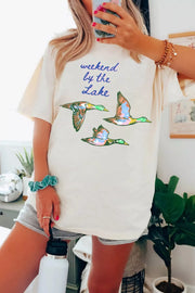 Cream cotton oversized tee with "weekend by the lake" graphic and flying ducks.
