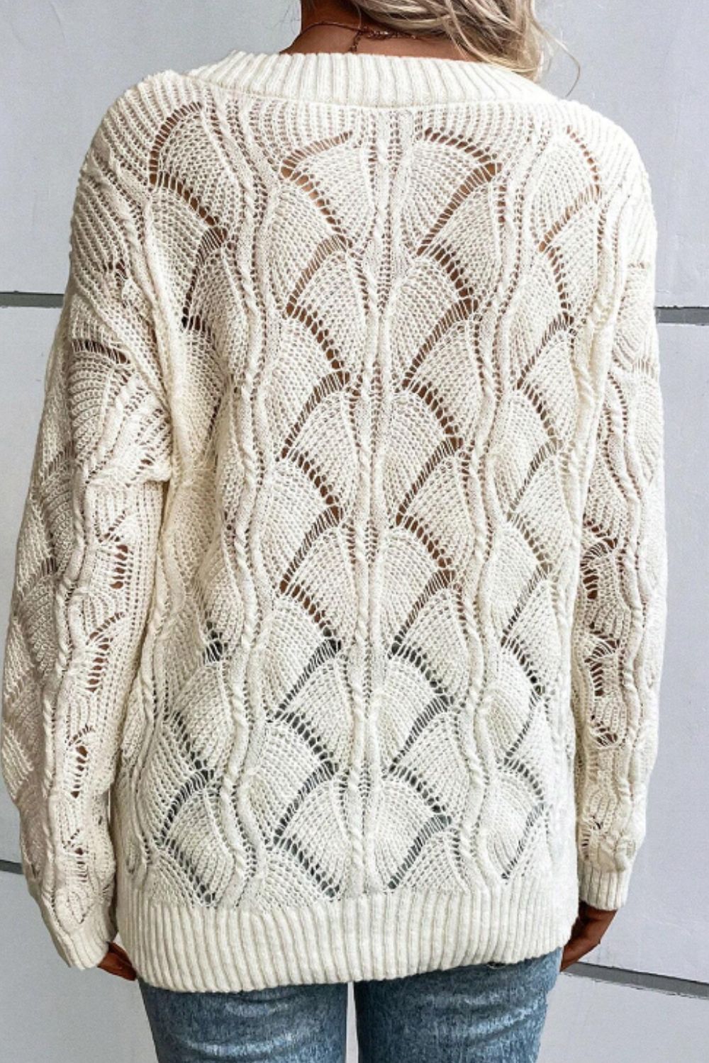 Ivory openwork knit V-neck pullover sweater with intricate fan-shaped pattern and ribbed trim.